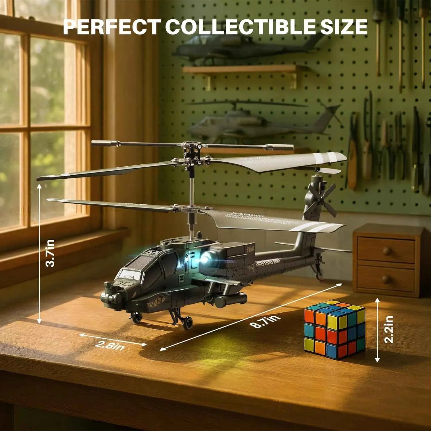 model rc helicopter on a table with measurements and a Rubik's cube for scale, against a pegboard background.