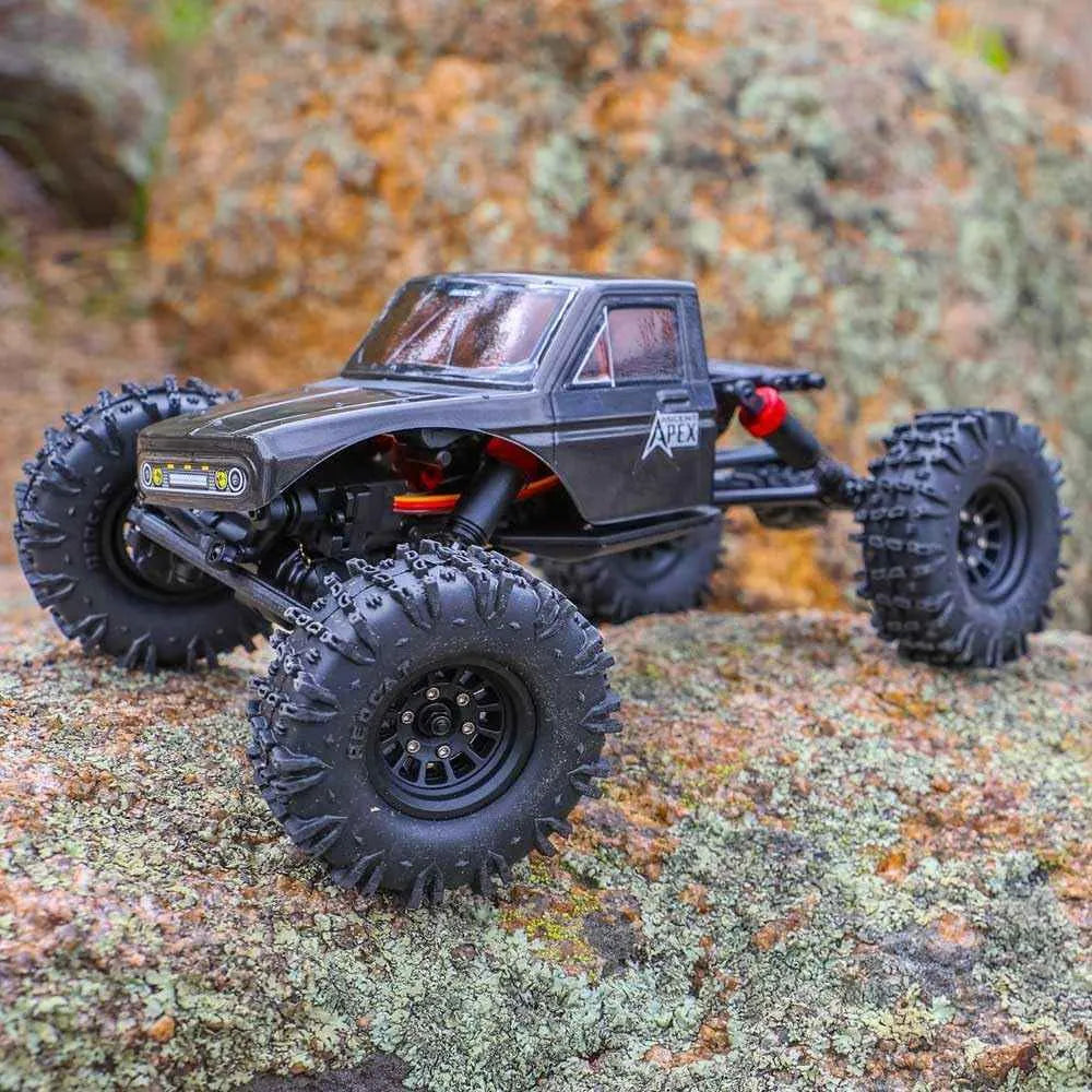 Model off-road crawler on a rocky surface with 'Apex' branding.