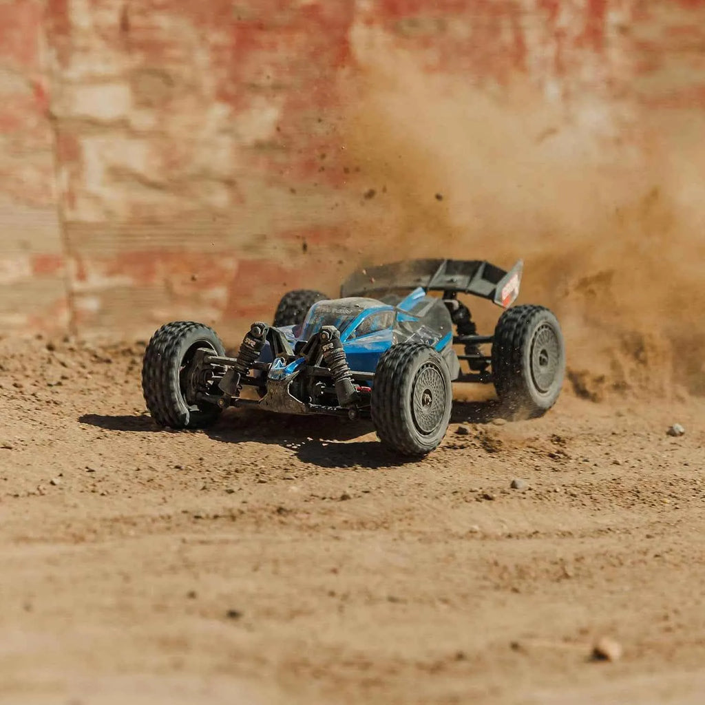 rc buggy off-road on a dirt track with dust in the air