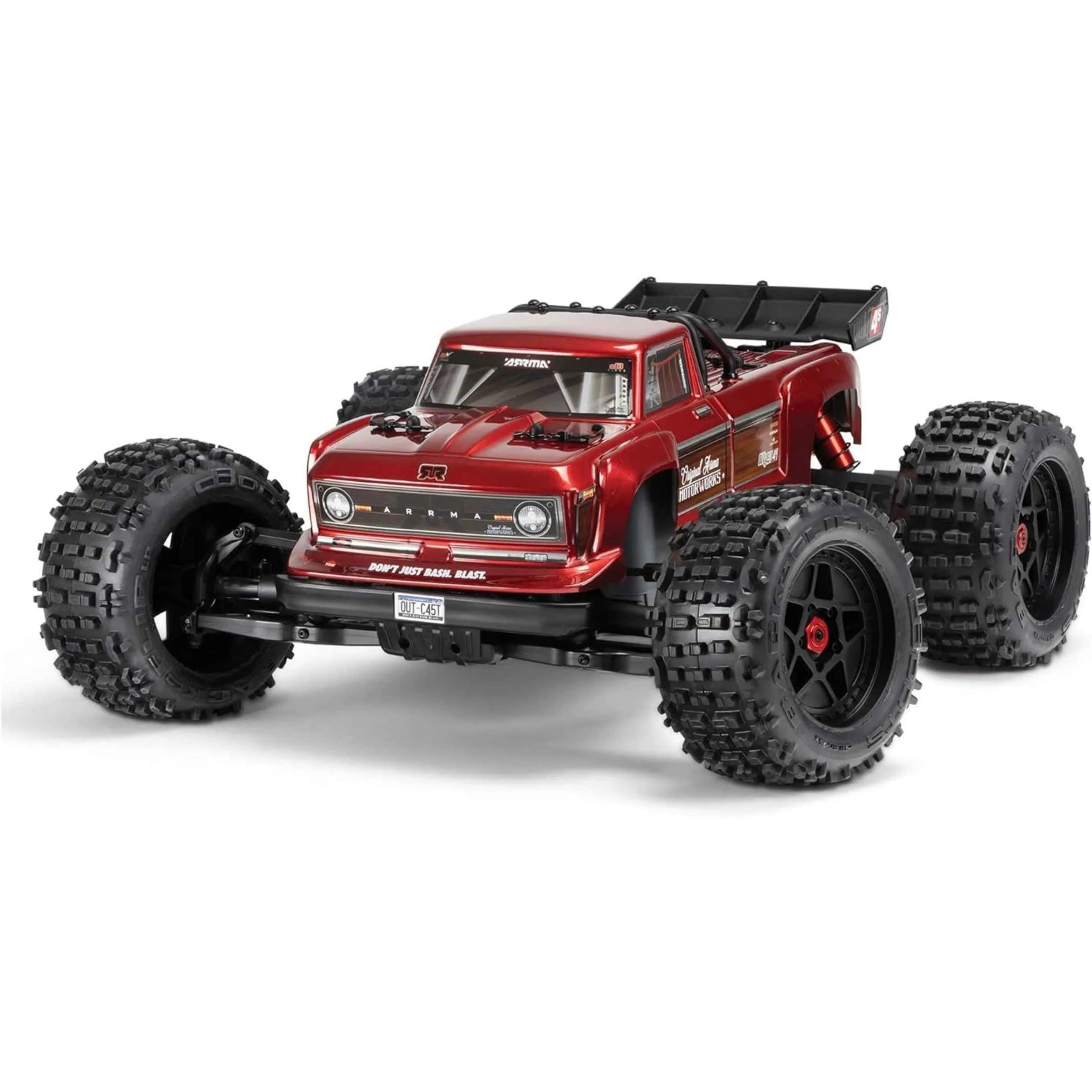 Red off-road rc monster truck with large black tires on a white background