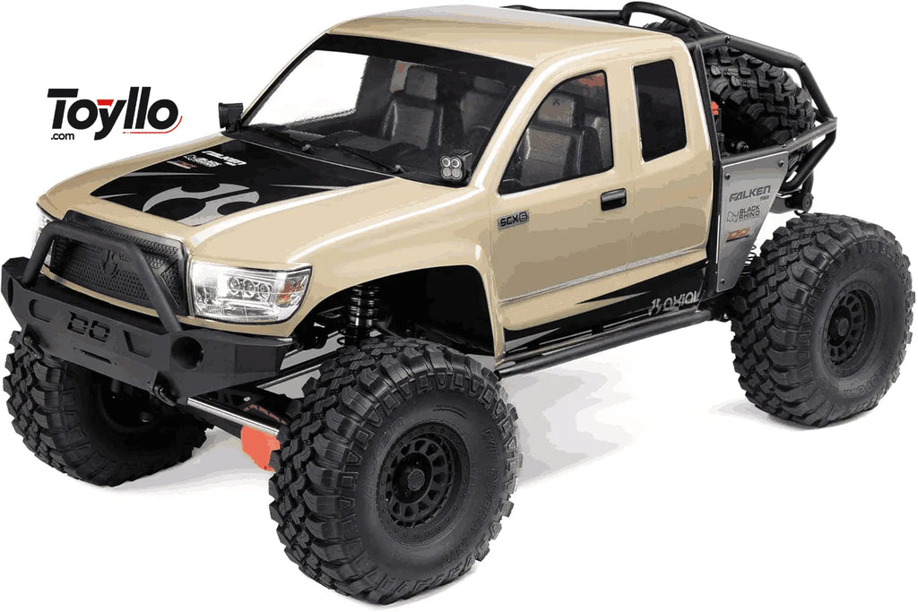 Beige RC crawler with large black wheels on a white background, featuring the Toyllo logo.