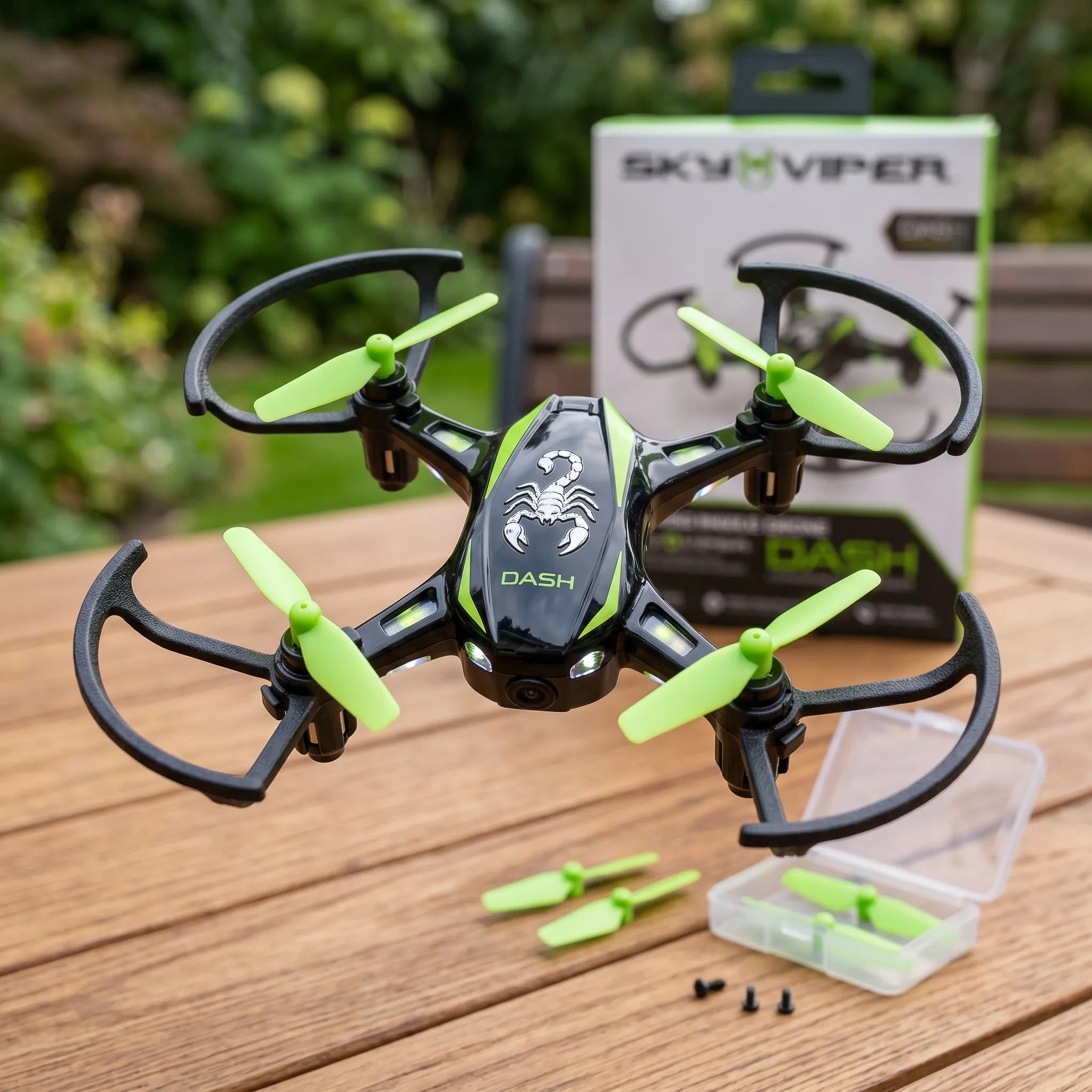 Black and green RC drone with 'SkyViper' packaging on a wooden surface