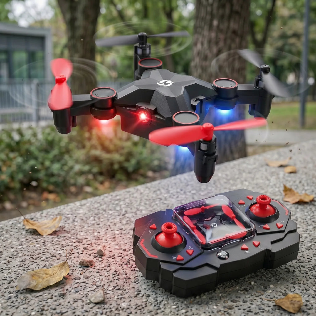 Black and red RC drone with propellers in flight, accompanied by a remote control on a concrete surface.