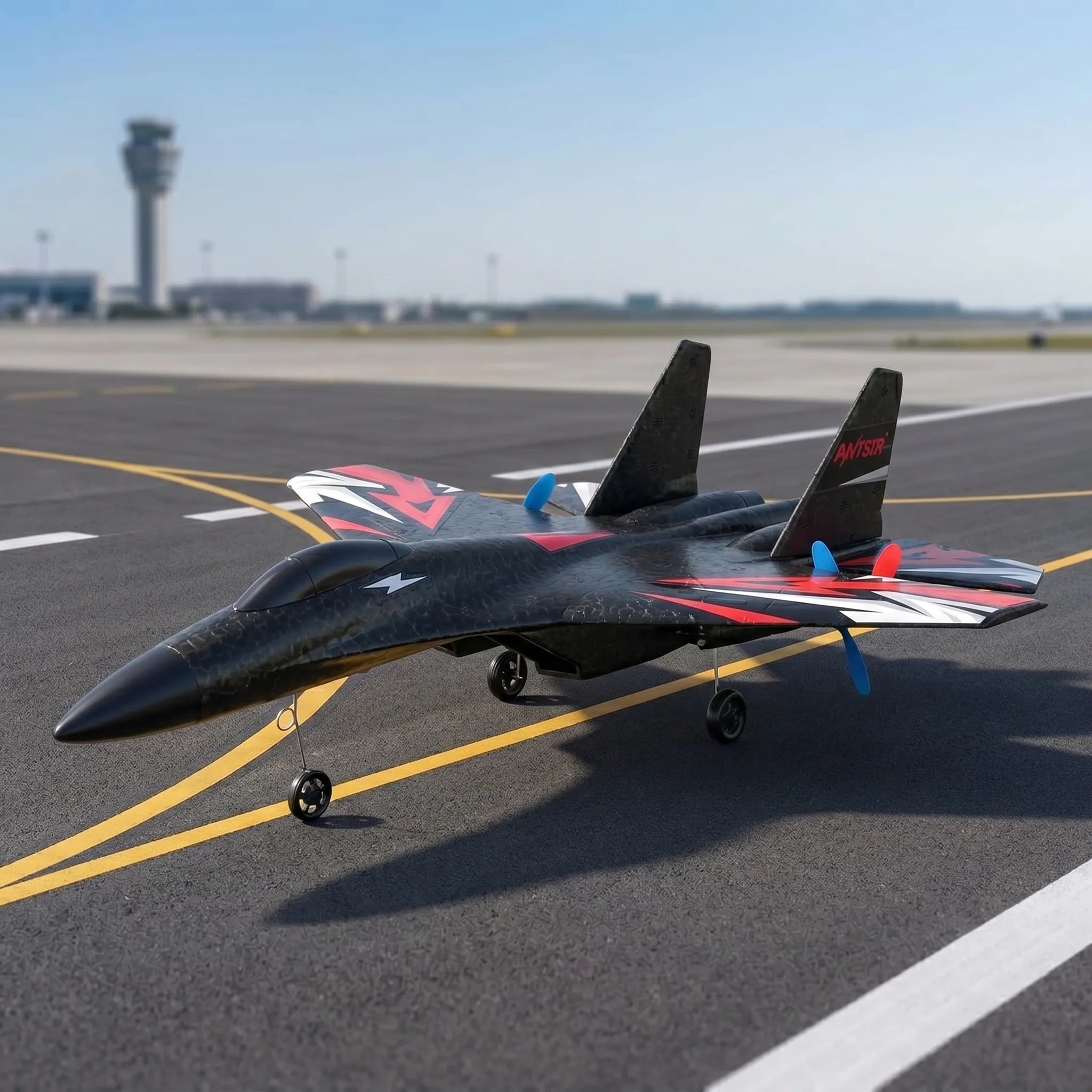 Black model of a RC fighter jet on an airport runway with control tower in the background