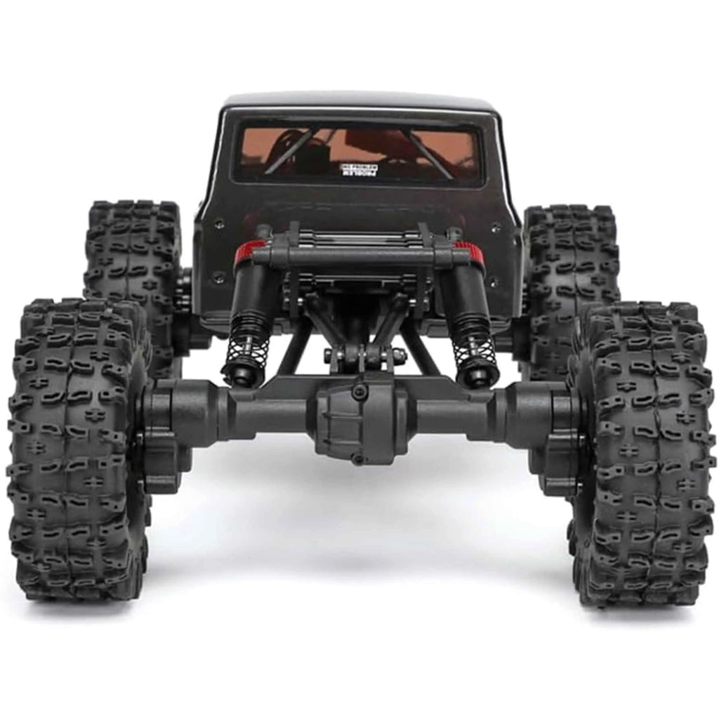 Black off-road RC crawler with large tires on a white background