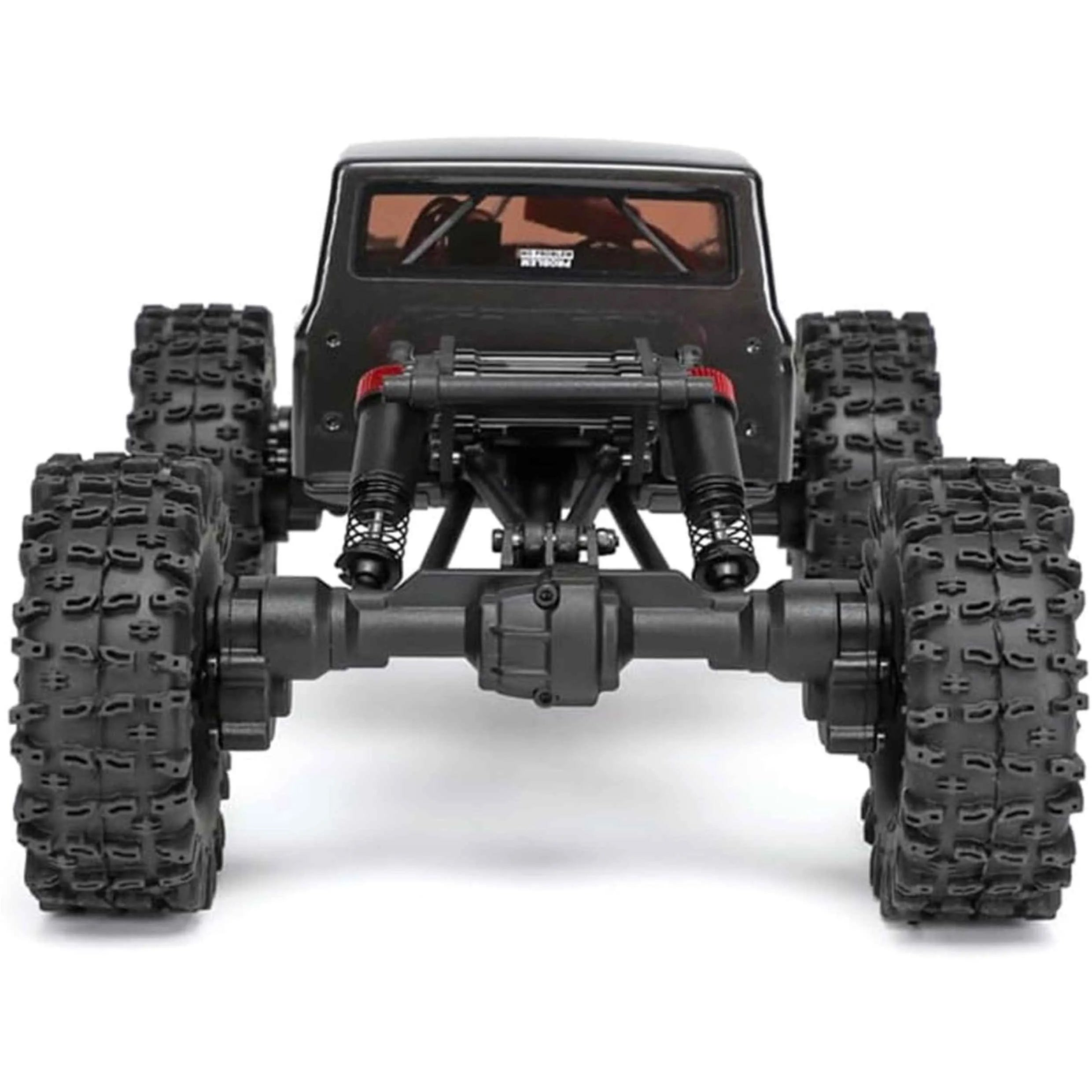 Black off-road RC crawler with large tires on a white background