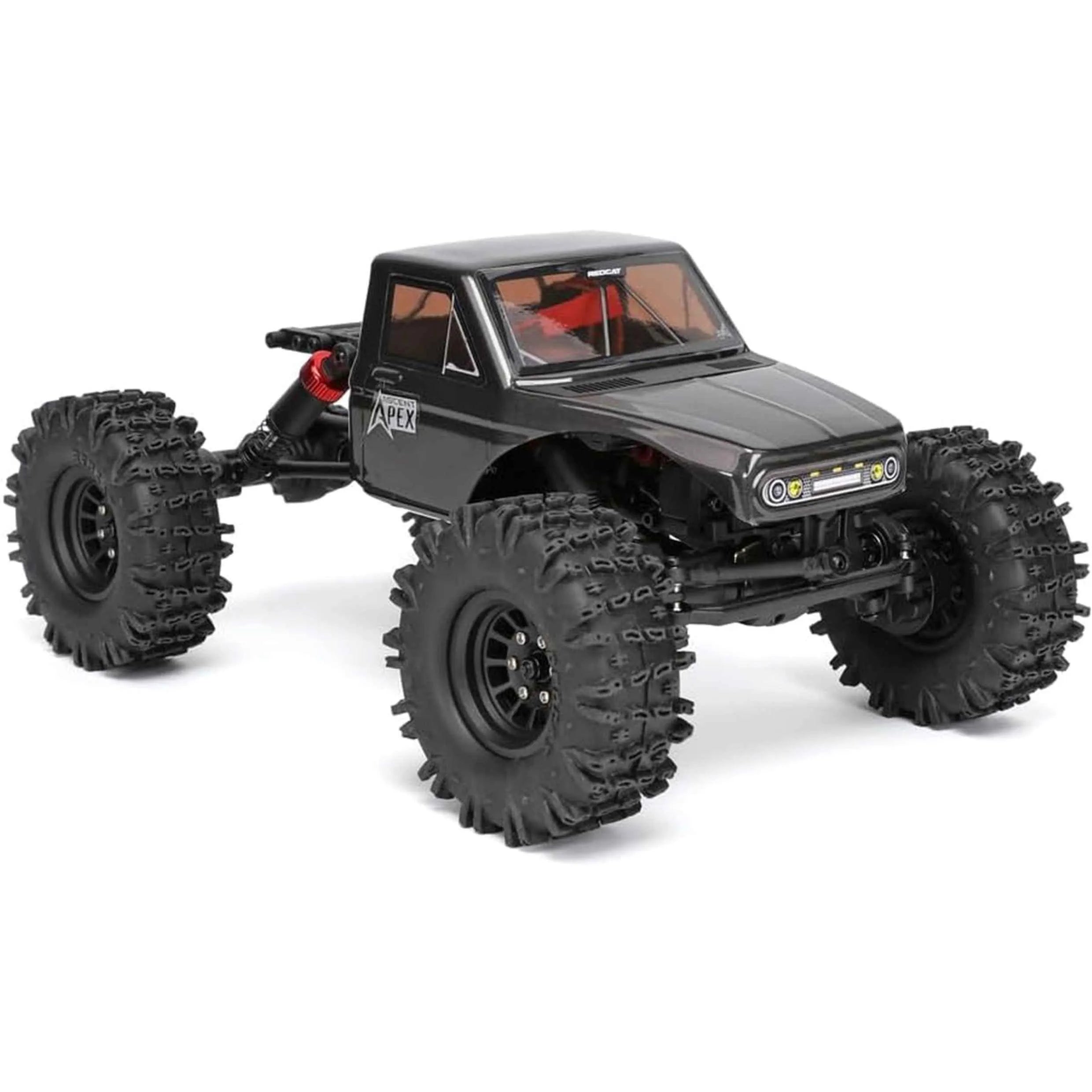 Black off-road RC crawler with large tires on a white background