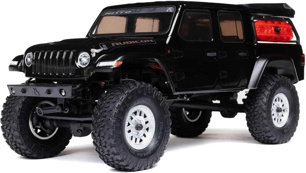 Black off-road RC crawler with large tires on a white background