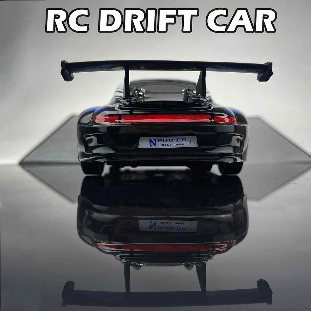 Black RC drift car with visible branding on a reflective surface