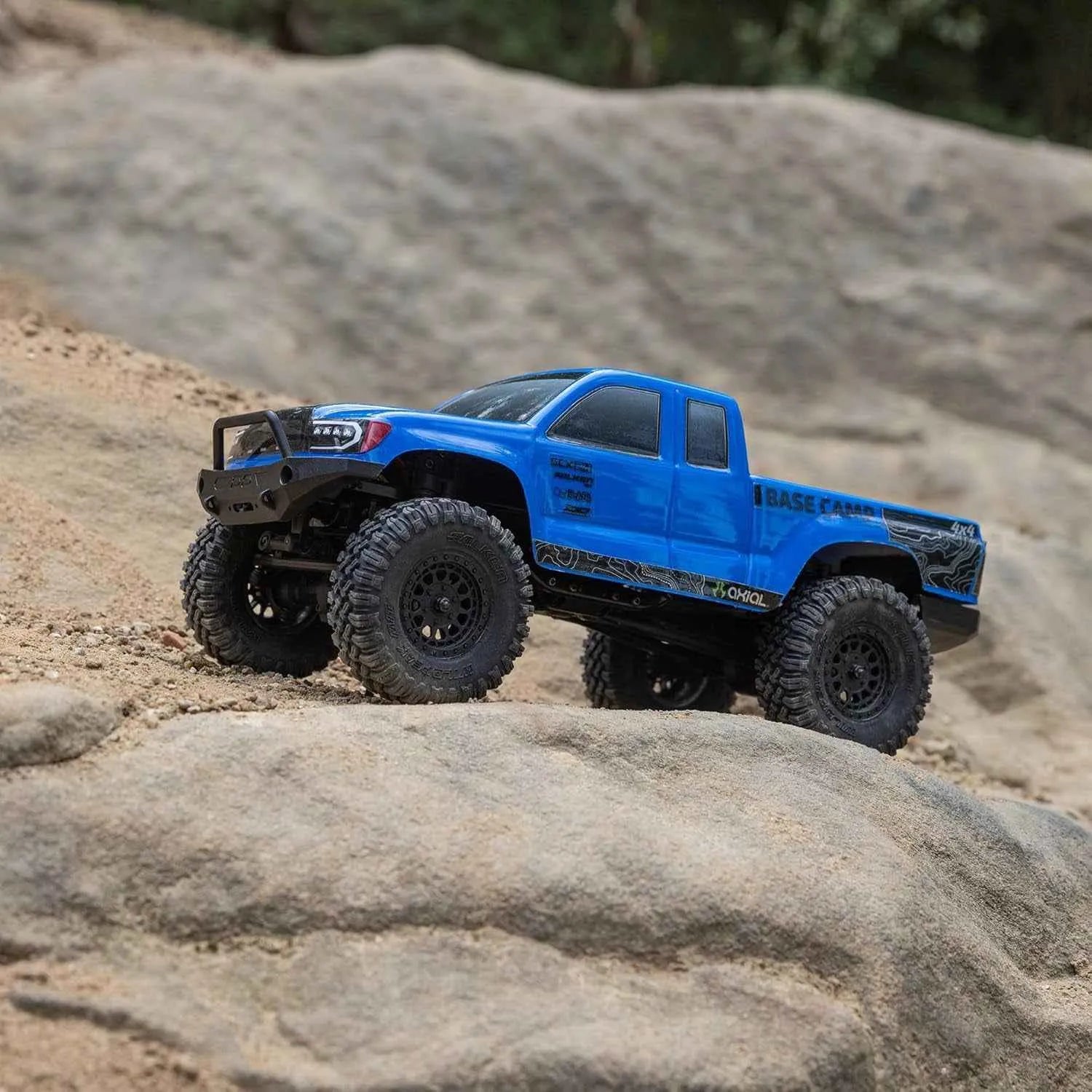 Blue off-road rock crawler on a rocky surface
