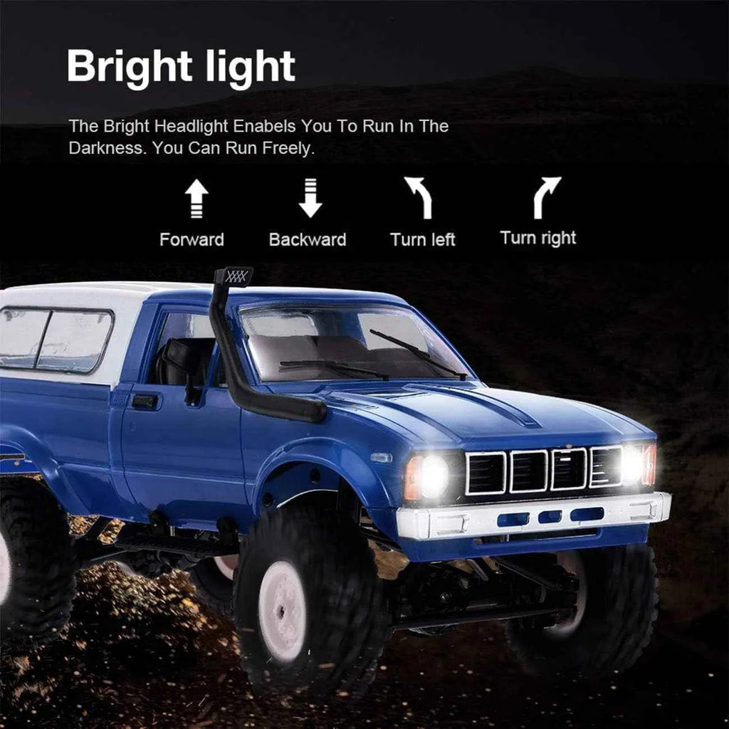 Blue RC crawler vehicle with bright headlights on a dark background