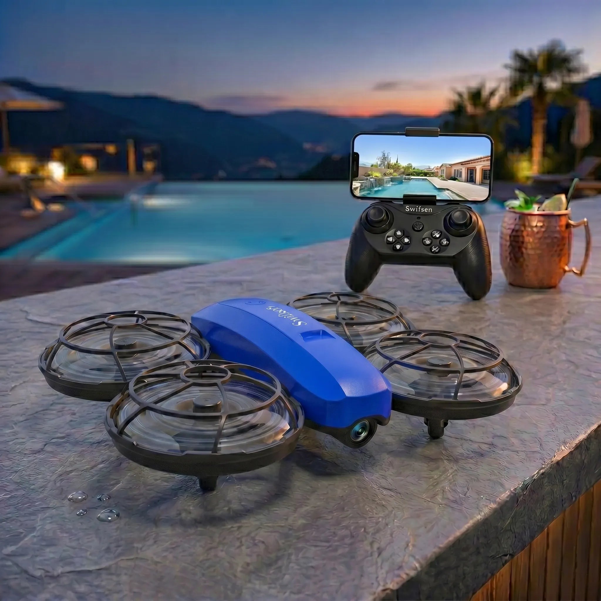 Blue RC drone on a table with a controller and smartphone displaying a live feed in a poolside setting.