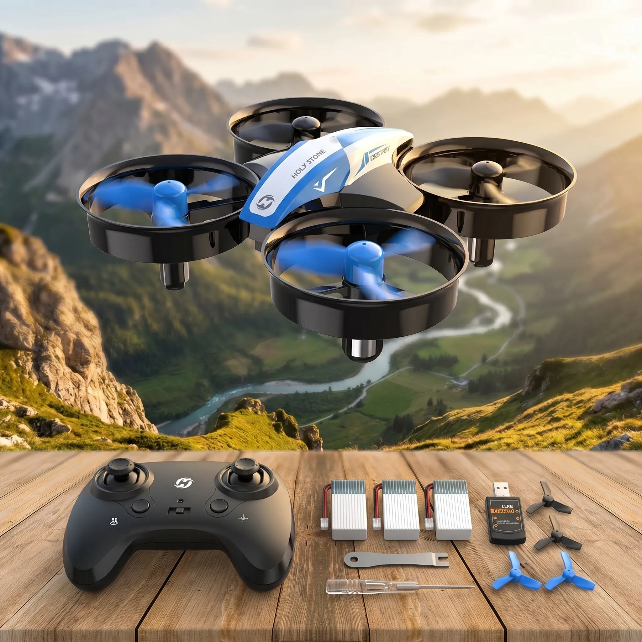 Blue RC Drone with controller and accessories on a wooden surface with a mountainous background