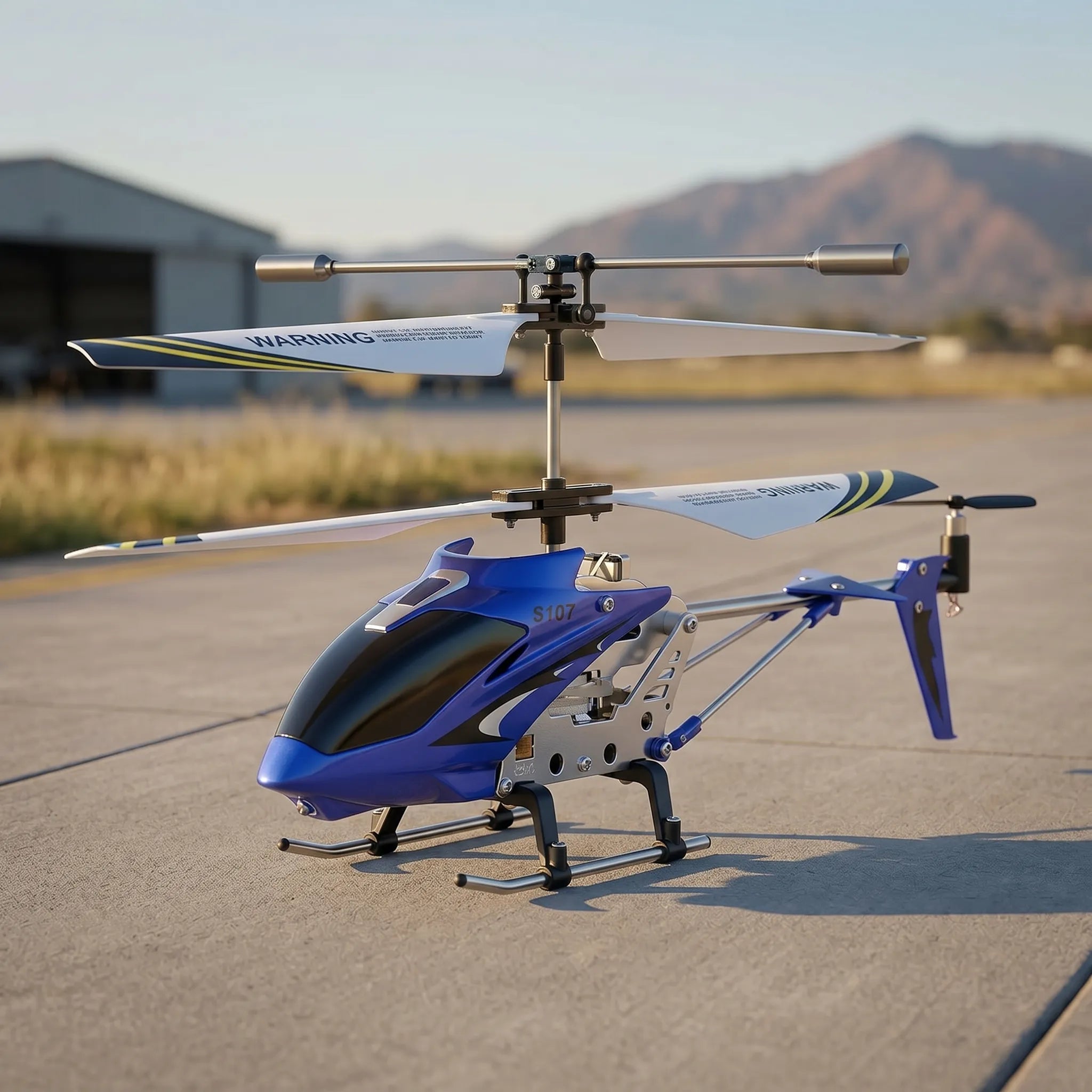 Blue RC toy helicopter on a tarmac with mountains in the background