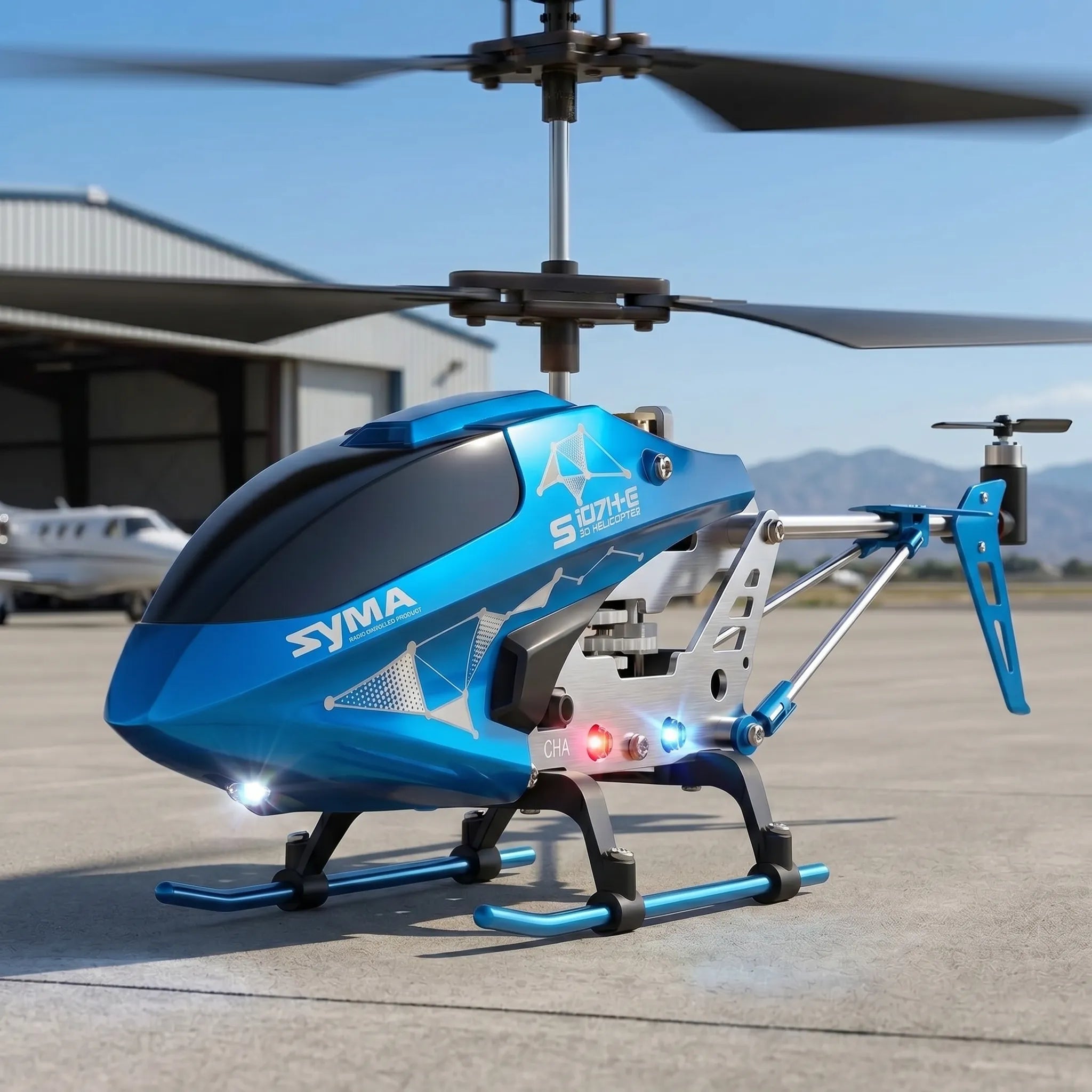 Blue Syma helicopter on a tarmac with mountains in the background