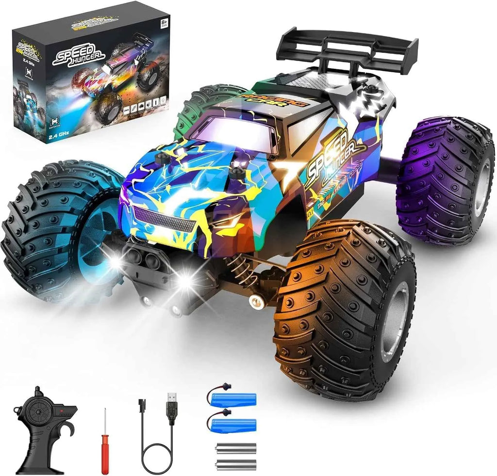 Colorful remote control monster truck with accessories on a white background