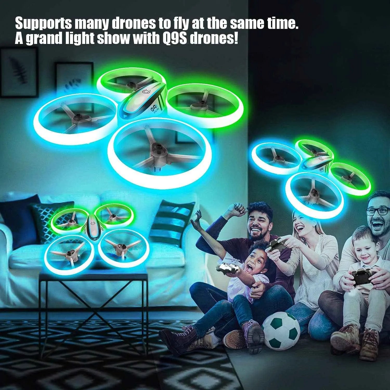 Glowing RC drones flying in a room with people watching on a screen.