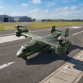 Green RC army plane on a runway with a blurred background