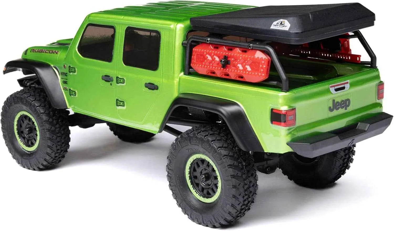 Green RC crawler with black roof rack and red toolbox on a white background