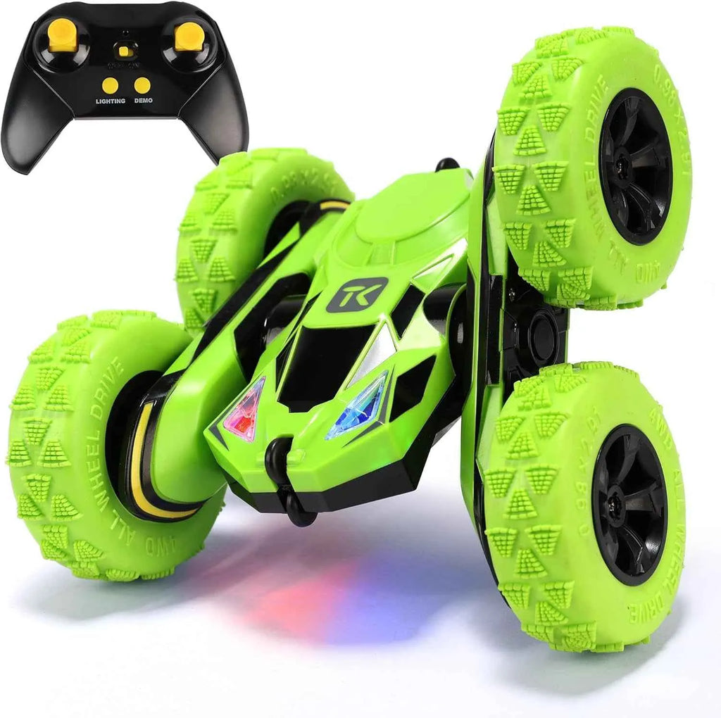 Green RC stunt car with remote control on a white background