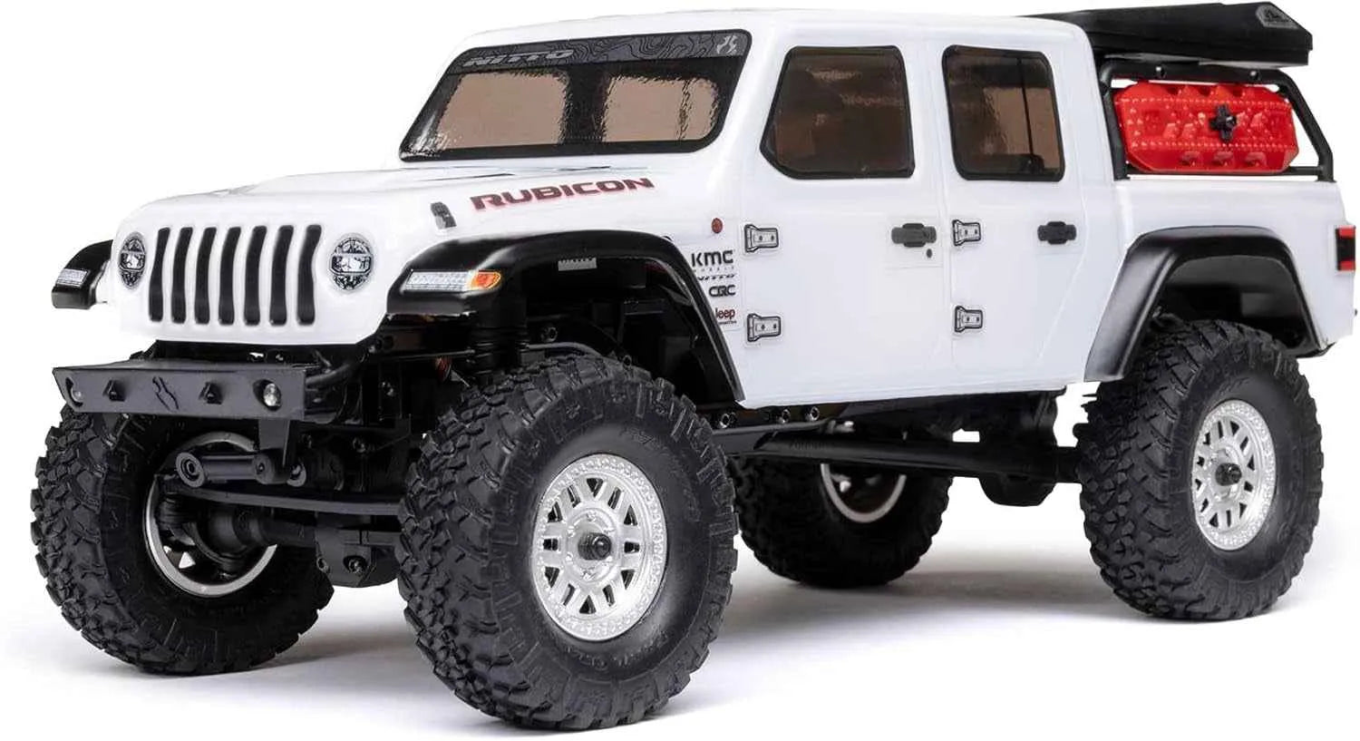 Model of a white RC crawler with large off-road tires on a white background