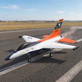 Model RC airplane on a runway with a clear sky background