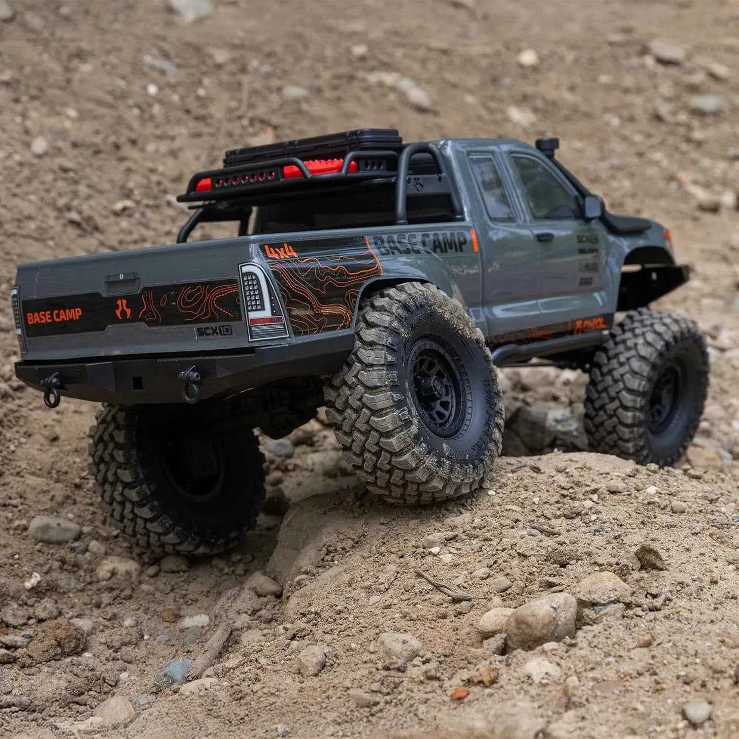 Model RC crawler with large tires on a dirt surface