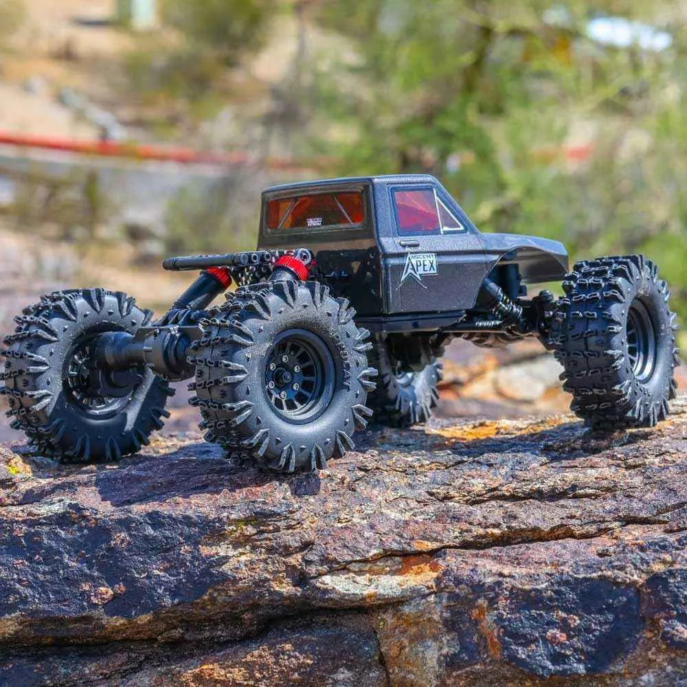 Model RC crawler with large wheels on a rocky surface