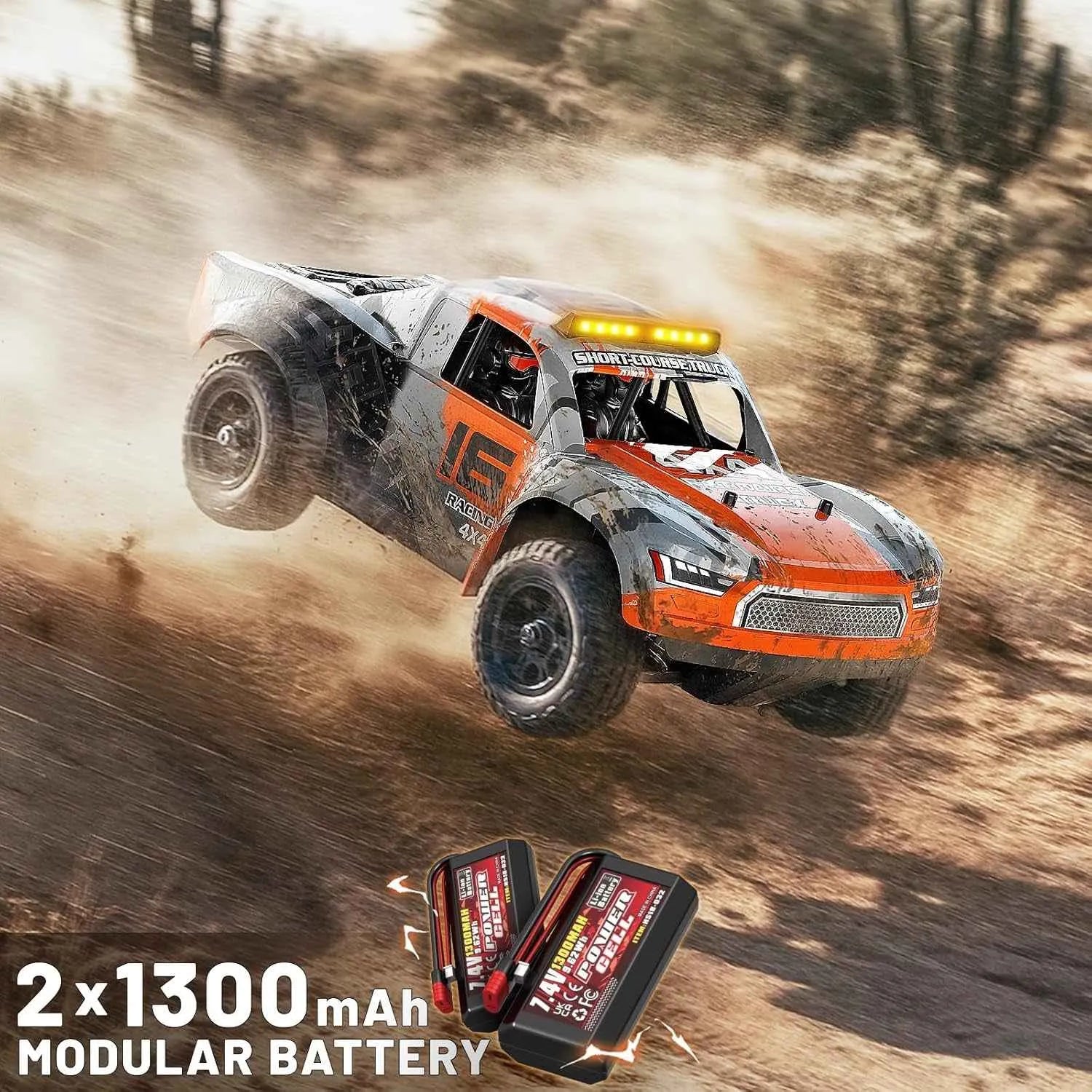 Off-road short course truck racing on a dirt track with modular battery pack displayed below.