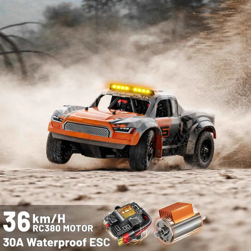 Orange remote control truck on a dirt track with electronic components displayed below.