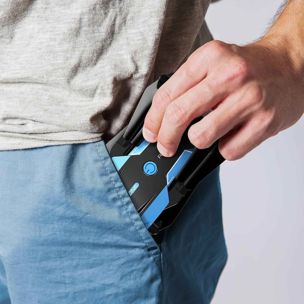Person inserting an RC drone into their jeans pocket with a plain background