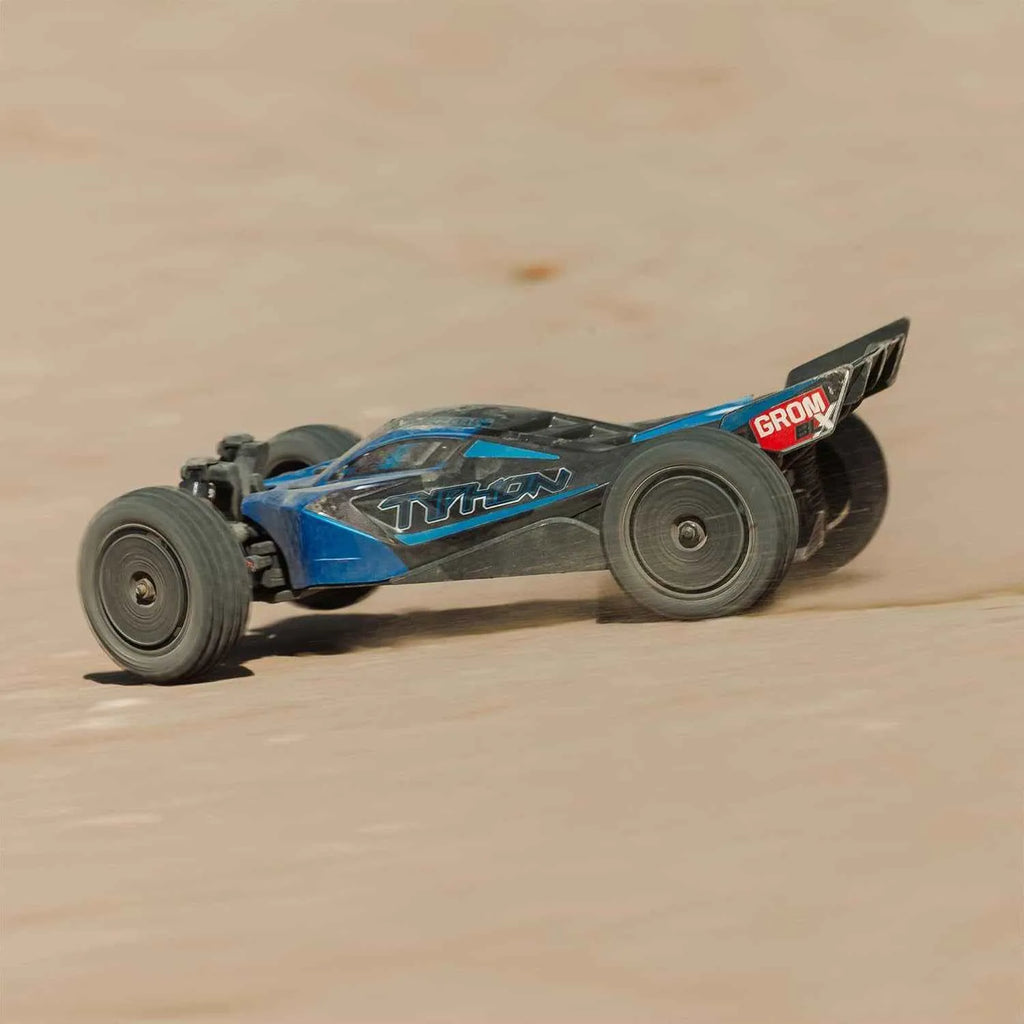Model off-road car on a sandy surface