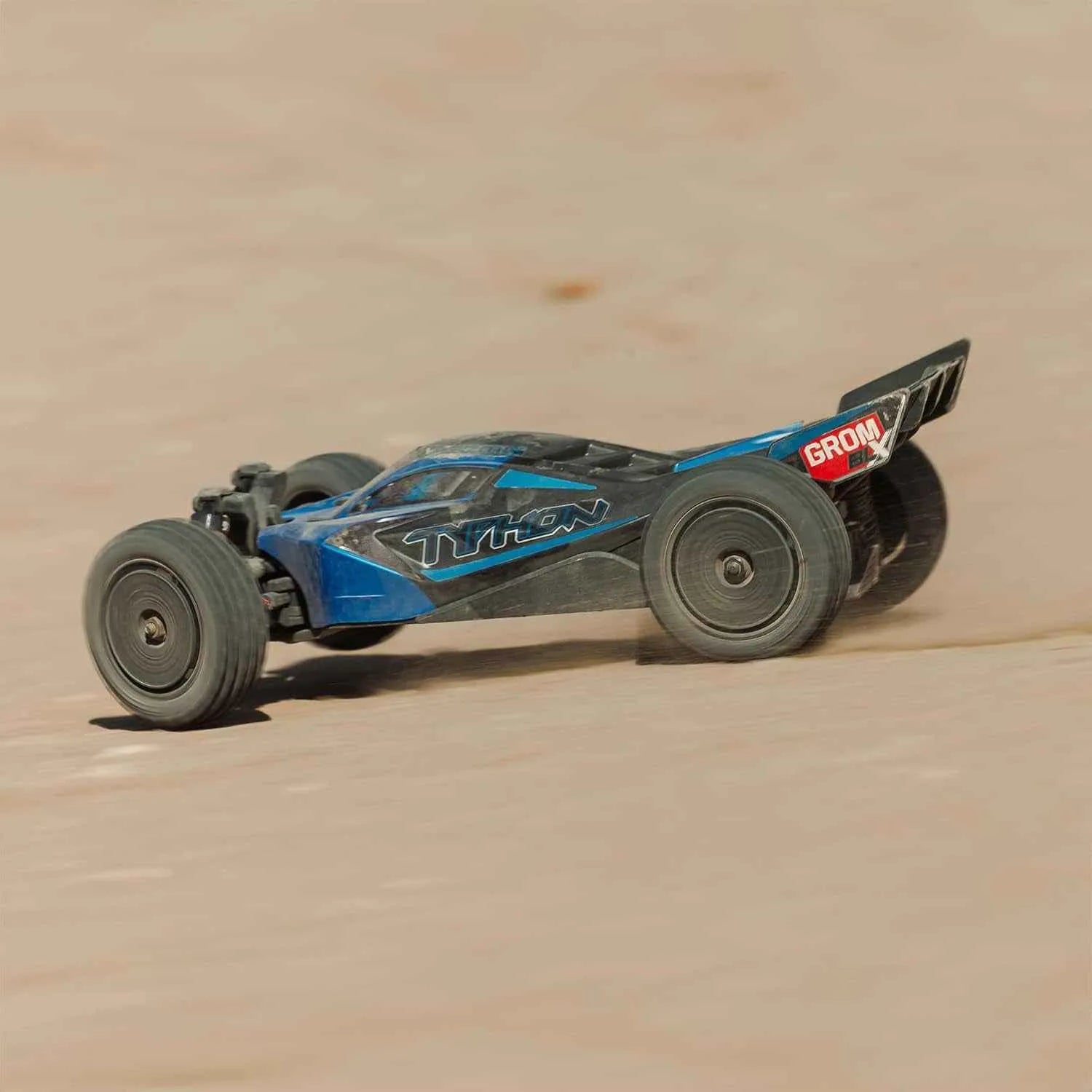 Model off-road car on a sandy surface