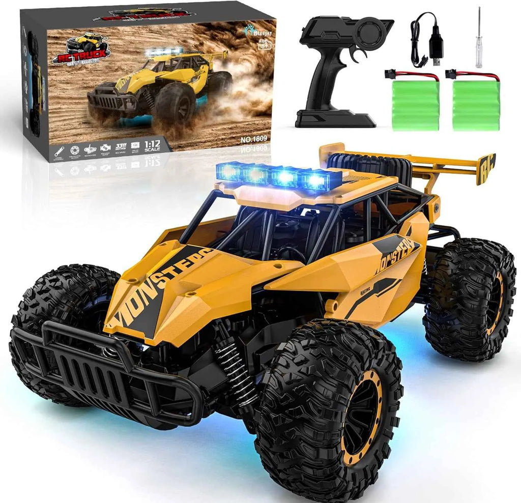 RC monster truck with lights and remote control, displayed with packaging and accessories on a white background.