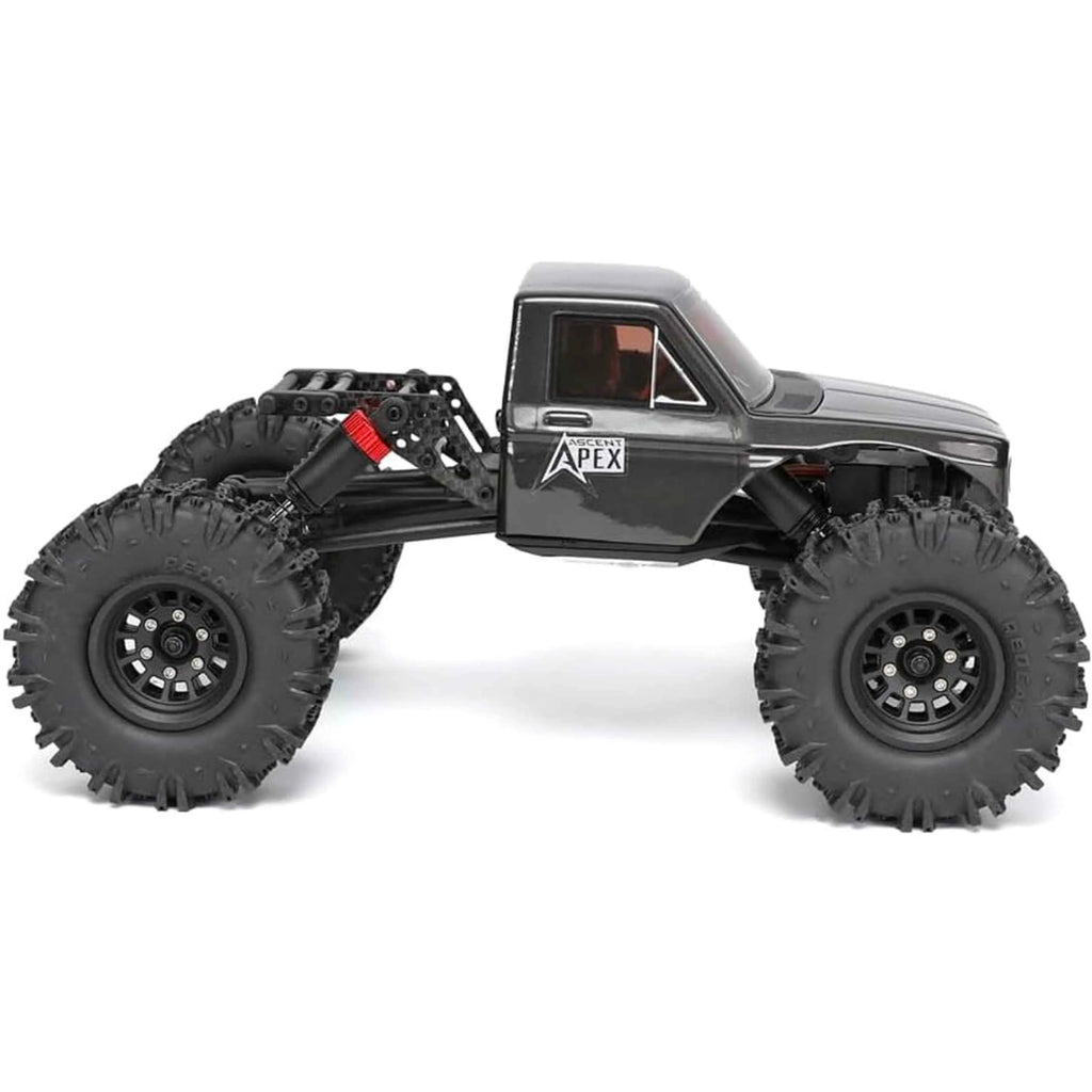 RC rock crawler with large wheels on a white background