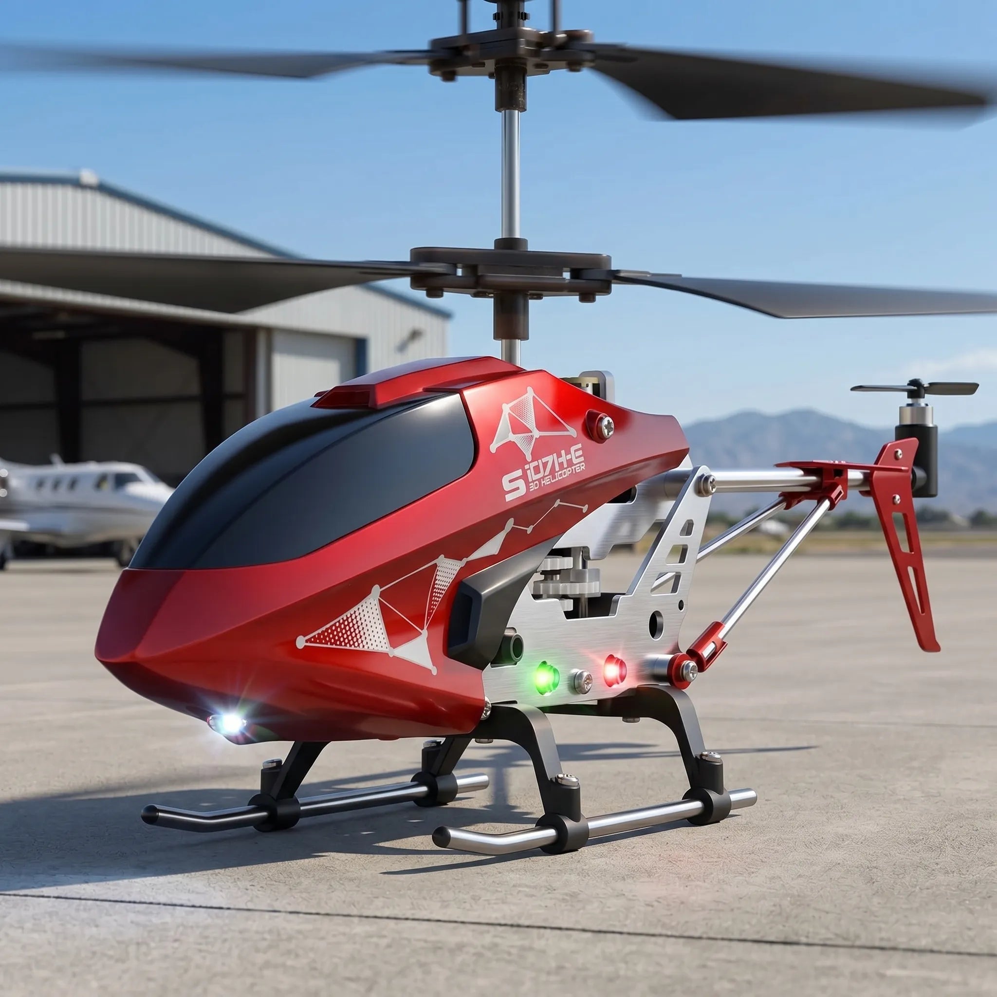 Red and black remote control helicopter on a tarmac with mountains in the background