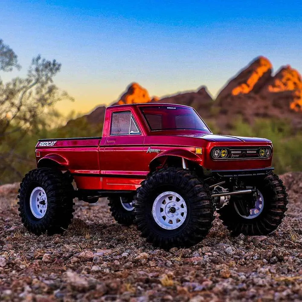 Red off-road crawler on a rocky terrain with desert landscape in the background