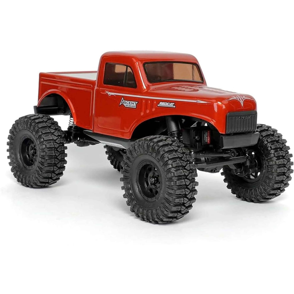 Red off-road crawler with large tires on a white background