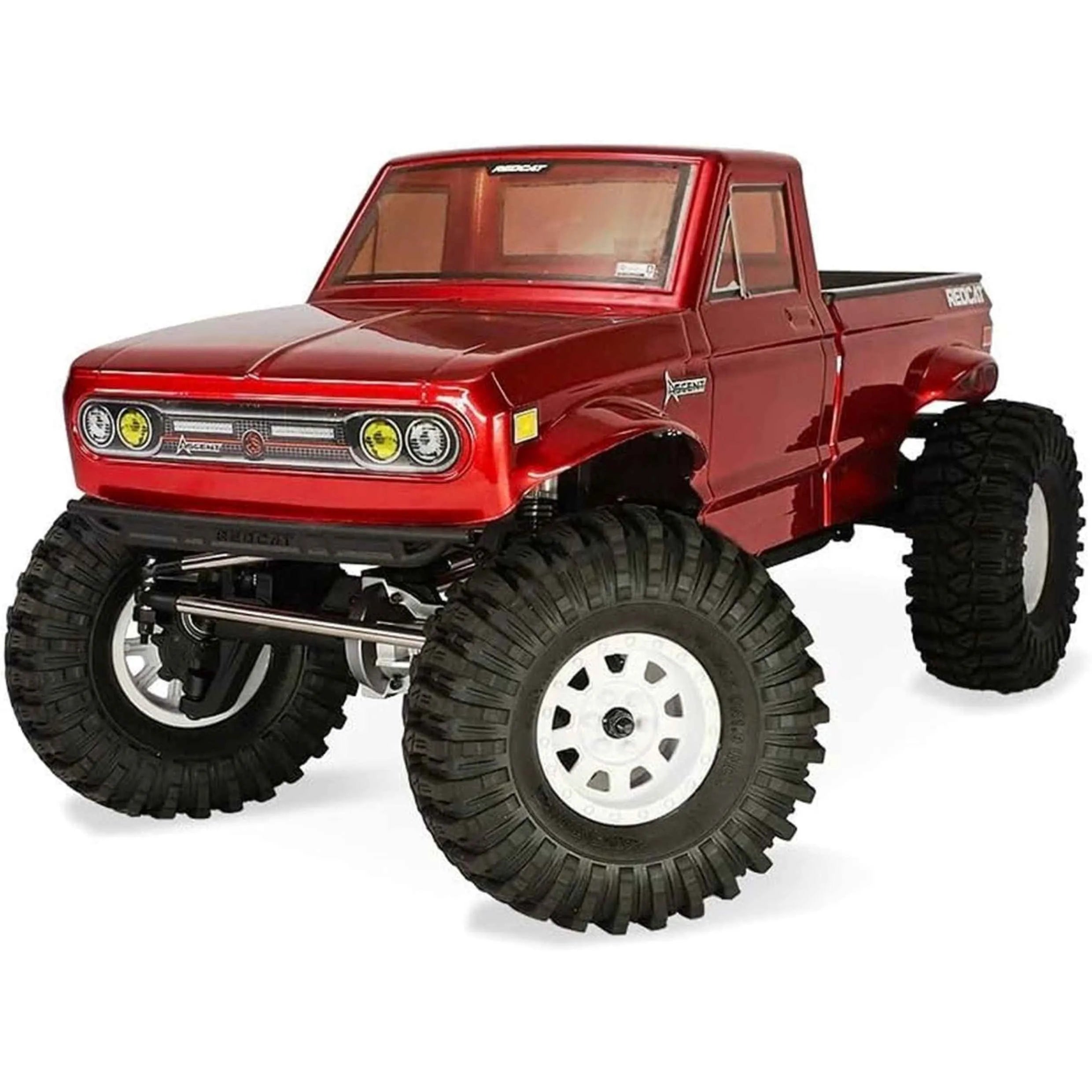 Red off-road rc crawler with large black tires on a white background