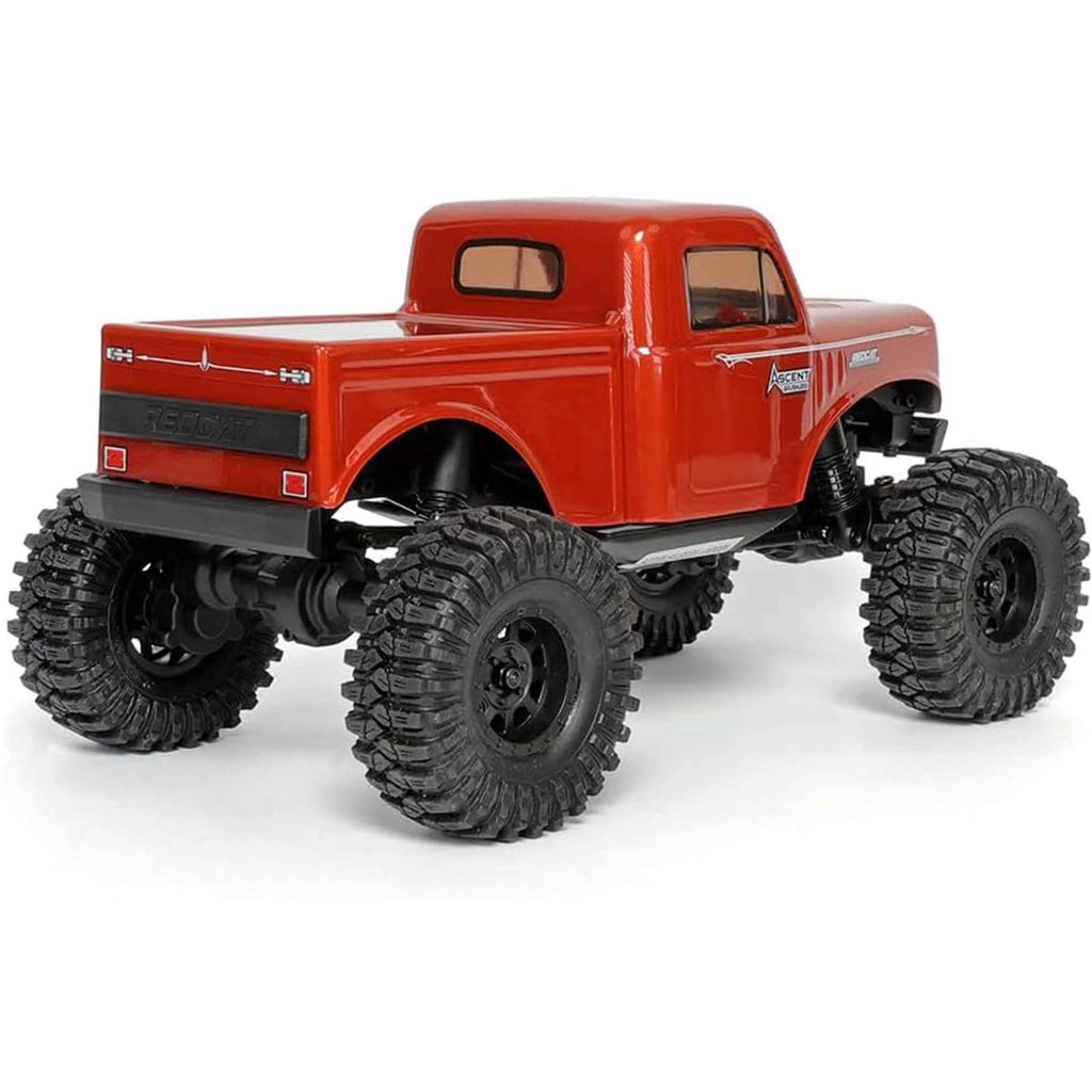 Red rc crawler back look with large black wheels on a white background