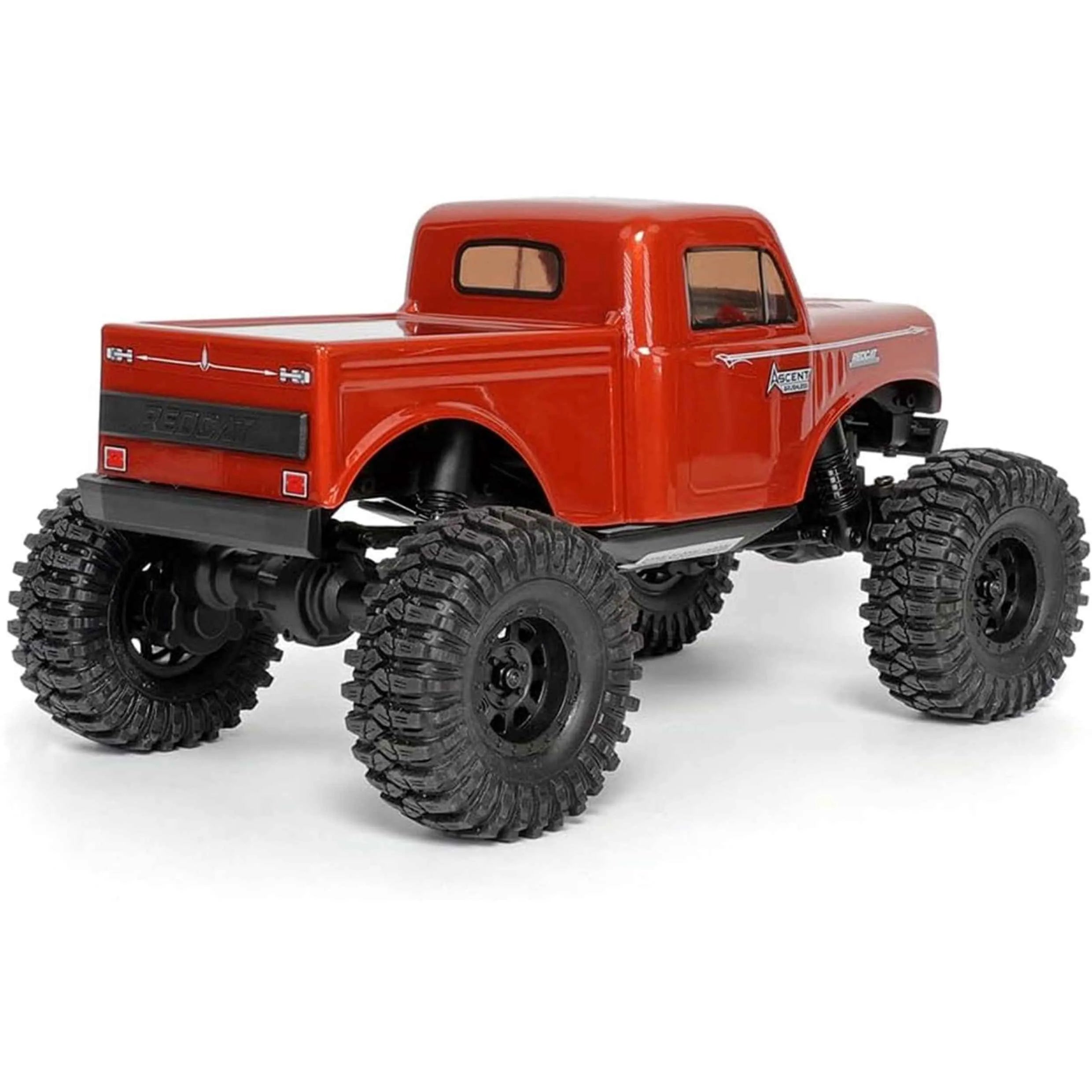 Red rc crawler back look with large black wheels on a white background