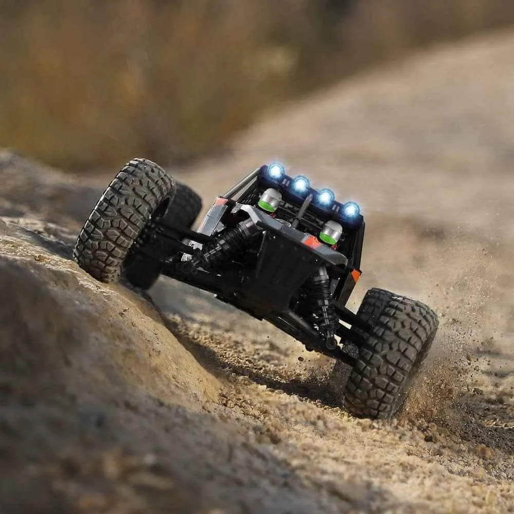 Remote control off-road vehicle climbing a sandy hill