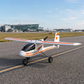 Small RC aircraft labeled 'AeroScout' on a runway with buildings in the background