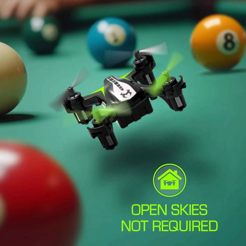 Small RC drone hovering over a pool table with pool balls in the background