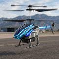 Toy RC helicopter with blue lights on a runway with mountains in the background