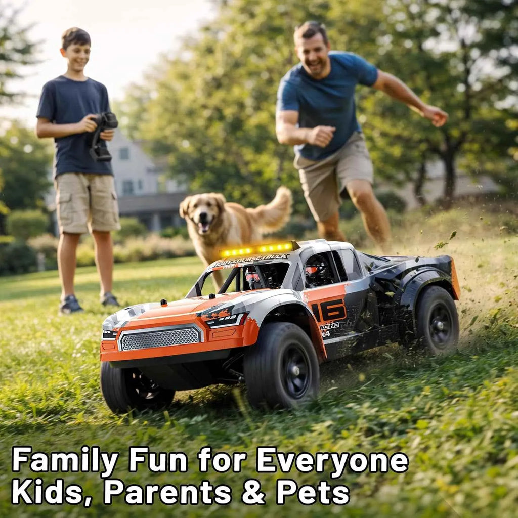Two people and a dog playing with a remote-controlled car in a grassy area.