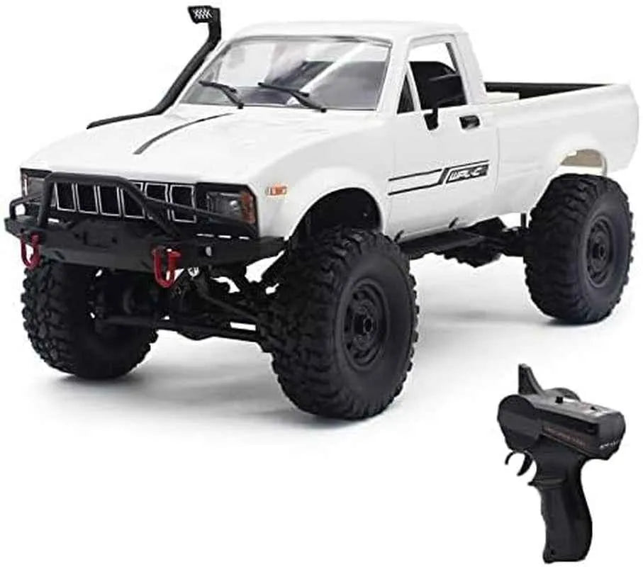 White off-road RC crawler with large tires and a remote control on a white background